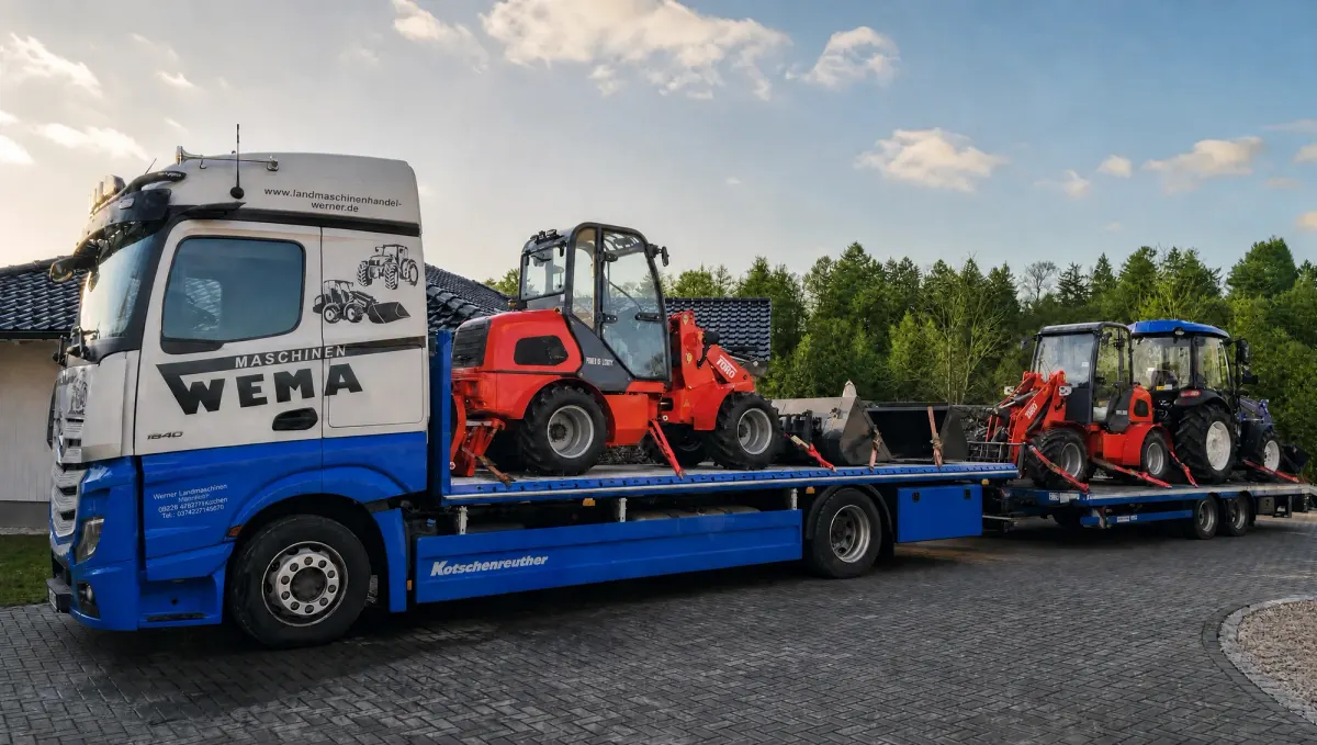 A lorry belonging to Werner Agricultural Machinery, loaded with farm loaders and a tractor